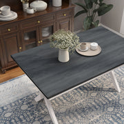 Right angled top view contemporary antique white and gray dining table with an X-cross base in a dining room with accessories