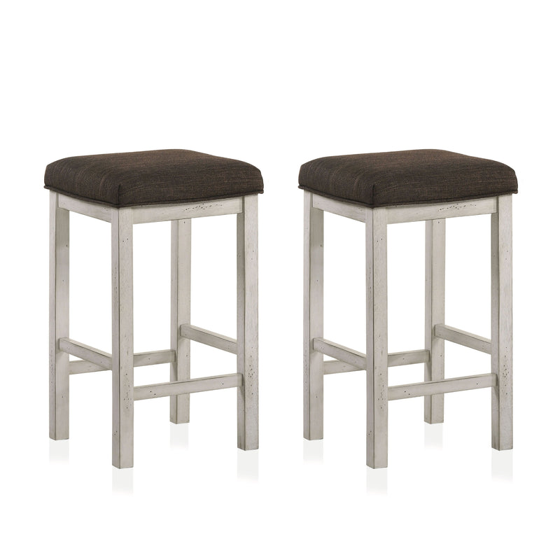 Right angled view of two rustic antique white counter height stools with dark brown fabric seats on a white background