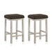 Right angled view of two rustic antique white counter height stools with dark brown fabric seats on a white background