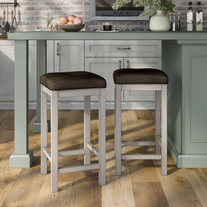 Right-angled two rustic antique white counter height stools with dark brown fabric seats in the dining room