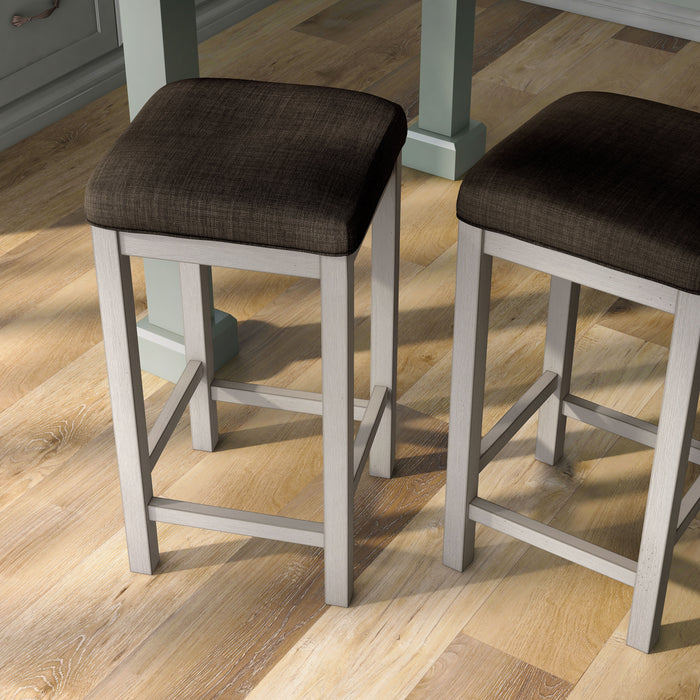 Right-angled top view of two rustic antique white counter height stools with dark brown fabric seats in the dining room