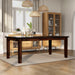 Right-angled rectangular wood dining table with tapered post legs in a casual dining room