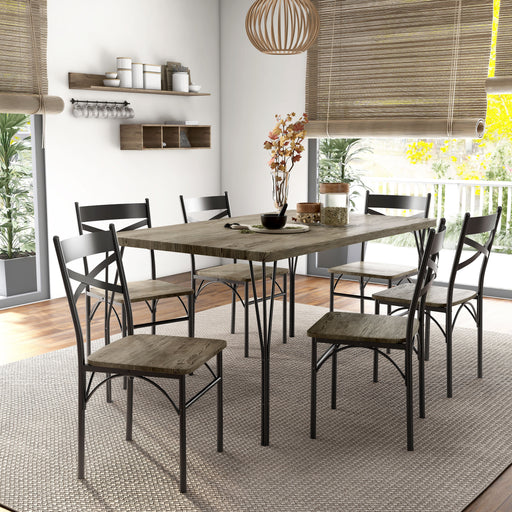 Left-angled seven-piece casual dining set with a rectangular wood grain table and six X-strap chairs in a casual dining room with accessories