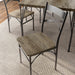 Left-angled close up X-strap chairs in a casual dining room with accessories