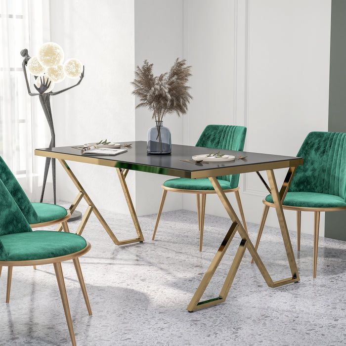 Left-angled modern glam rectangular dining table in black and gold with a geometric base in a contemporary dining room with chairs and accessories