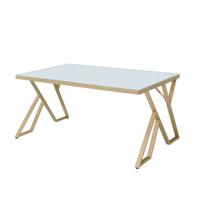 Left-angled modern glam rectangular dining table in white and gold with a geometric base on a white background