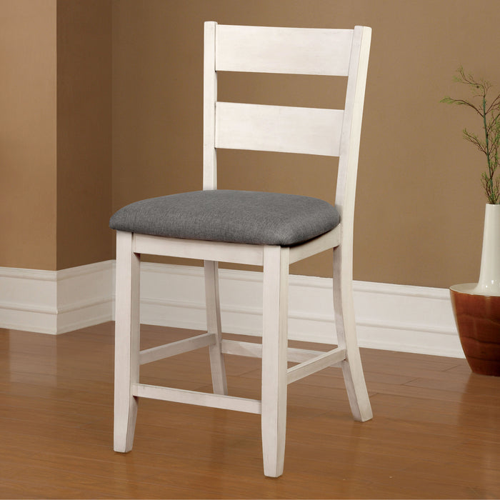 Left angled rustic counter height chair in antique white and gray in a dining room