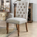 Left angled rustic pine and ivory button tufted dining chair in a living area with accessories
