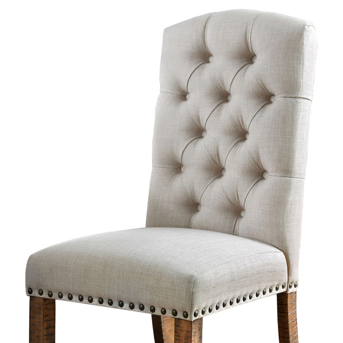 Left angled close up rustic pine and ivory button tufted dining chair upholstery and seat detail on a white background