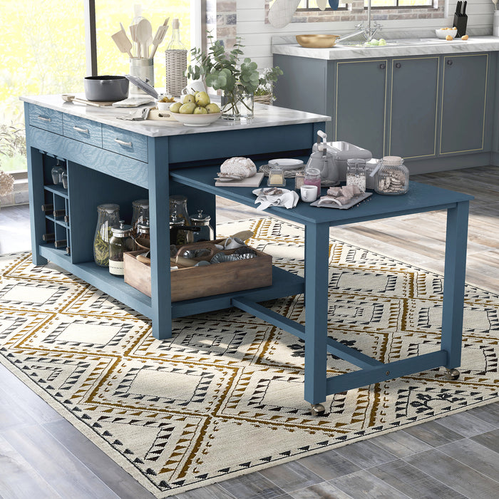 Left angled view of farmhouse blue counter height table with white marble-like tabletop and table extension with accessories used as kitchen island