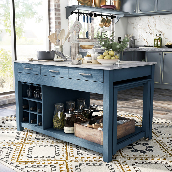 Left angled view of farmhouse blue counter height table with white marble-like tabletop and hidden table extension with accessories used as kitchen island