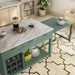 Right angled top-down view of farmhouse green counter height table with white marble-like tabletop and extended rolling table with accessories used as kitchen island