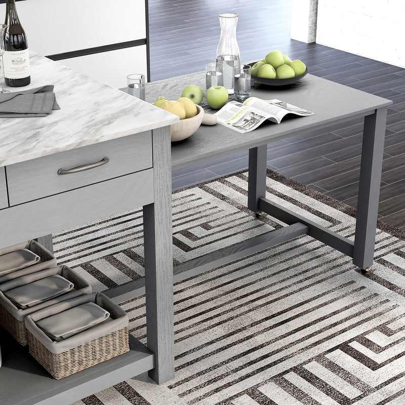 Right angled top-down view of extended hidden table and white marble-like tabletop of farmhouse light gray counter height table with decor in a kitchen