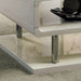 Right angled close up contemporary white geometric coffee table corner and leg detail in a living room with accessories