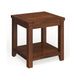 Right angled view of transitional cherry wood end table with open bottom shelf on a white background