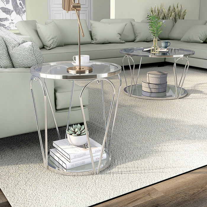 Left angled view of modern round chrome coffee table and end table set with teardrop legs and mirrored lower shelves decorated in a living room
