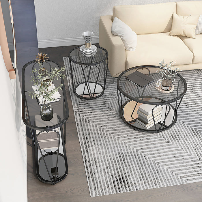 Right angled top-down view of modern round black nickel coffee table, end table, and console table with teardrop legs and mirrored lower shelf with decor in a living room