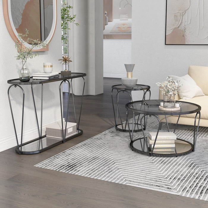 Right angled side view of modern round black nickel coffee table, end table, and console table with teardrop legs and mirrored lower shelf with decor in a living room