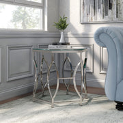 Right angled glam chrome and glass top hexagon side table in a living room with accessories