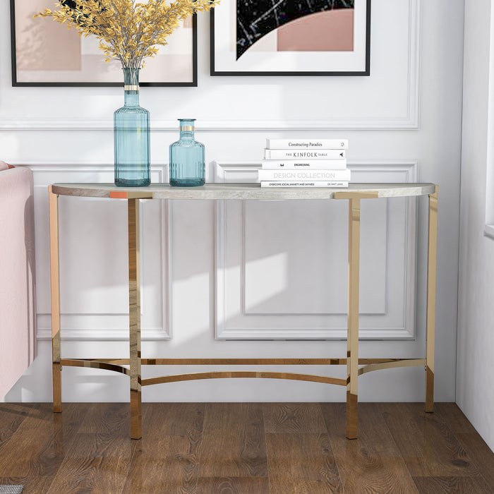 Front-facing view of modern glam demilune console table with white faux marble tabletop and champagne steel base decorated in a living room setting