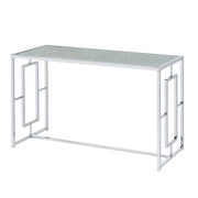 Left angled view of modern chrome plated steel sofa table with geometric trestle base and waterfall pattern tempered glass top on a white background