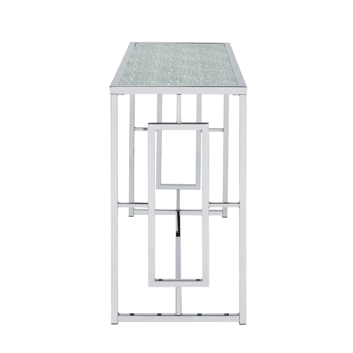 Front-facing side view of modern chrome plated steel sofa table with geometric trestle base and waterfall pattern tempered glass top on a white background