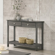 Left angled view of transitional gray console table with open bottom shelf and two drawers decorated in a living room