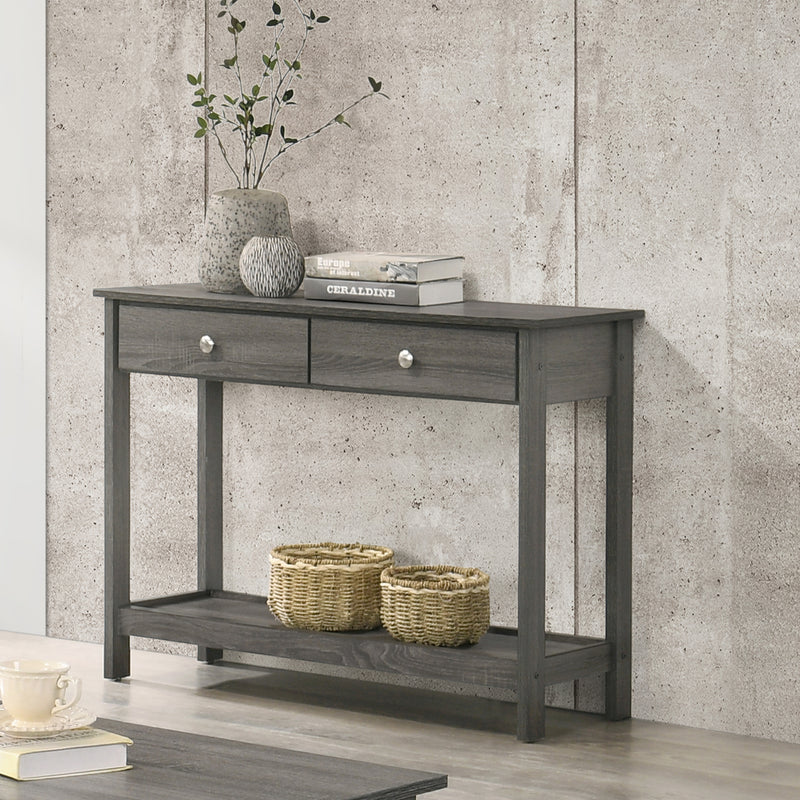 Left angled view of transitional gray console table with open bottom shelf and two drawers decorated in a living room