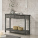 Left angled view of transitional gray console table with open bottom shelf and two drawers decorated in a living room 