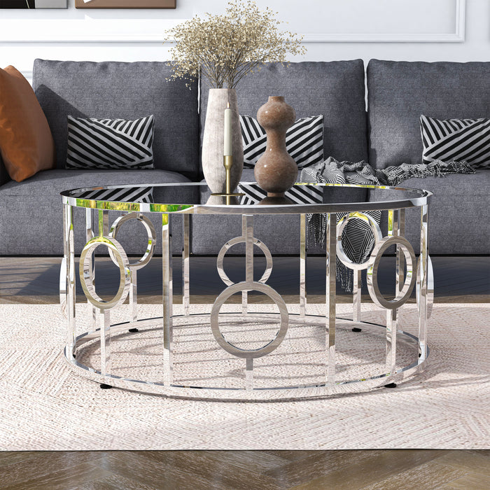 Front facing contemporary chrome and mirror coffee table in a living room with accessories