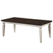Semi-side facing view of transitional antique white and brown finish wood coffee table on a white background