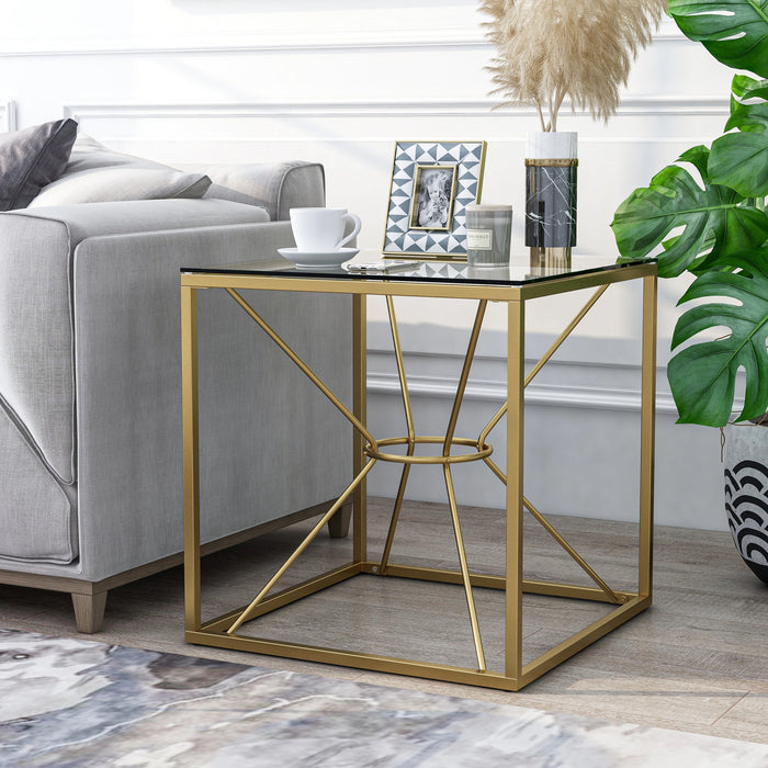 Left angled glam gold and glass square end table in a living room with accessories