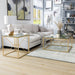 Right angled glam gold and glass square end table in a living room with accessories and matching coffee table