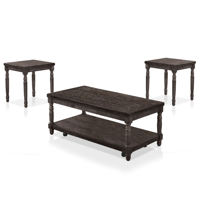 Left angled contemporary gray wood coffee table and two matching end tables on a white background. Carved legs and wood plank tabletops offer rustic touch.