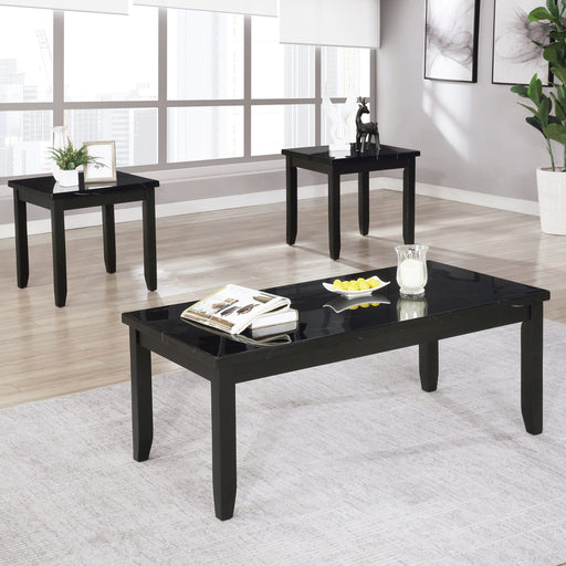 Right angled transitional gray wood coffee table and matching end tables with decor in a living room setting. Tapered block style legs and faux marble tops offer traditional flair.