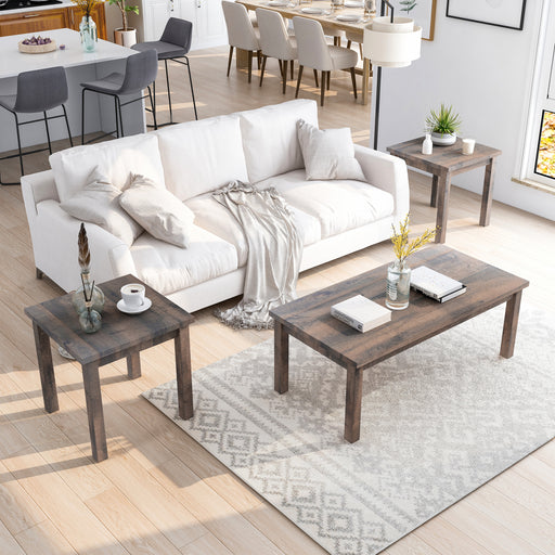 Right angled top view of a rustic three-piece wood living room table set in a living room with accessories