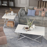 Left angled top view of a glam two-piece chrome and white geometric coffee table set in a living room with accessories