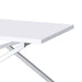 Left angled close up corner detail of a glam chrome and white geometric coffee table on a white background