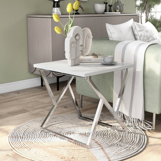 Left angled contemporary chrome and high gloss white end table in a living room with accessories