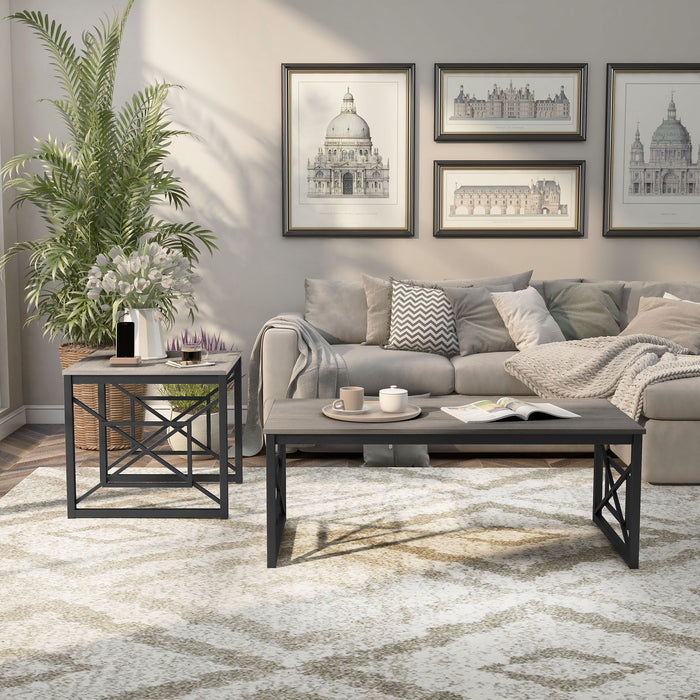 Front-facing transitional gray rectangular coffee table and side-facing transitional gray end table with geometric black metal sled bases on a rug in a living room setting.
