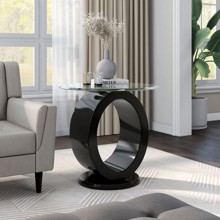 Angled view of contemporary geometric glossy black and tempered glass top end table in living room with accessories