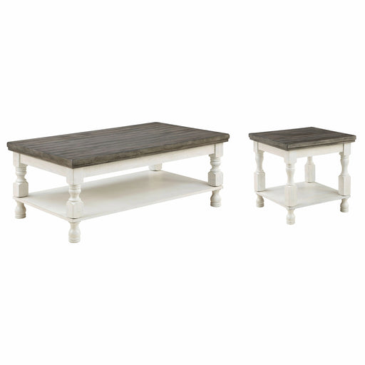 Left angled rustic gray wood coffee table and matching gray wood end table with antique white open shelf bases on a white background. 