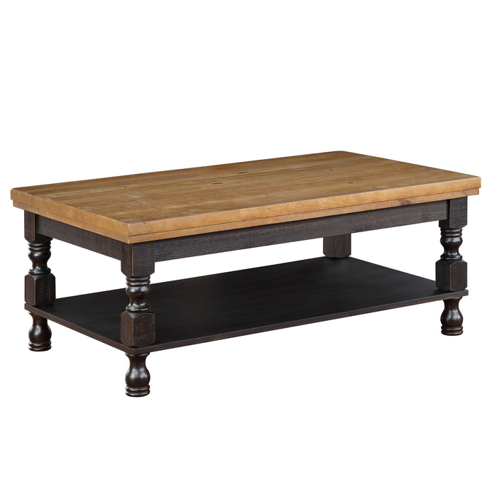 Right angled rustic antique black wood coffee table with oak tabletop and open lower shelf on a white background.