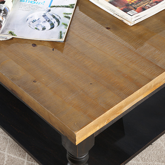 Left angled top-down oak tabletop detail of rustic antique black wood coffee table with decorative accessories on a rug.