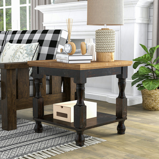 Left angled transitional one-shelf antique black and oak end table in a living room with accessories