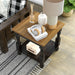 Right angled top view of a transitional one-shelf antique black and oak end table in a living room with accessories