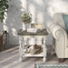 Front-facing transitional one-shelf antique white and gray wood end table in a living room with accessories