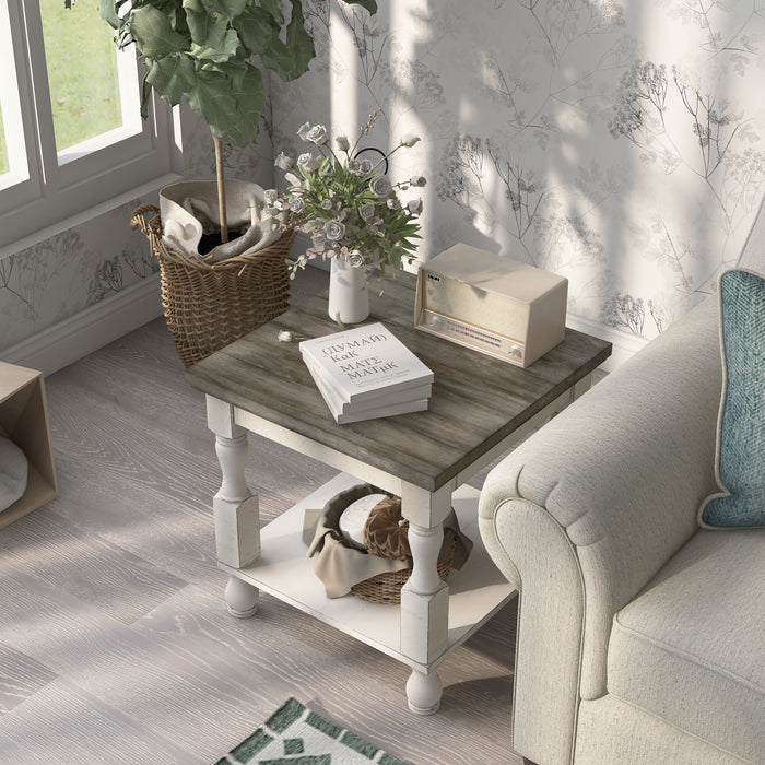 Top-view of a transitional one-shelf antique white and gray wood end table in a living room with accessories