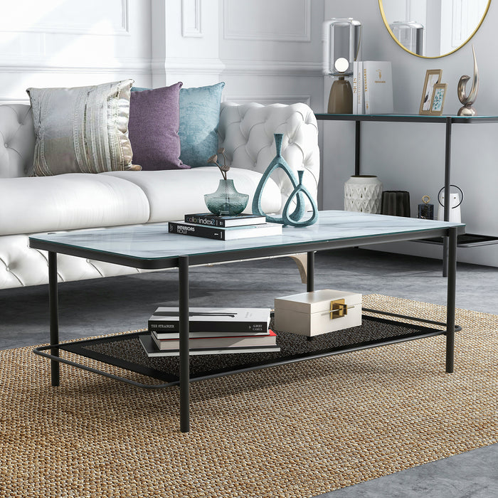 Right angled modern industrial black steel coffee table with tempered white marble glass top, slender steel legs and perforated open metal shelf with decor in a living room.