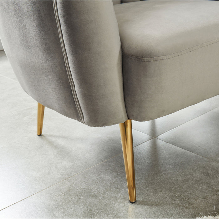 Right-angled close up modern glam shell tufted loveseat base and leg detail on a tile floor